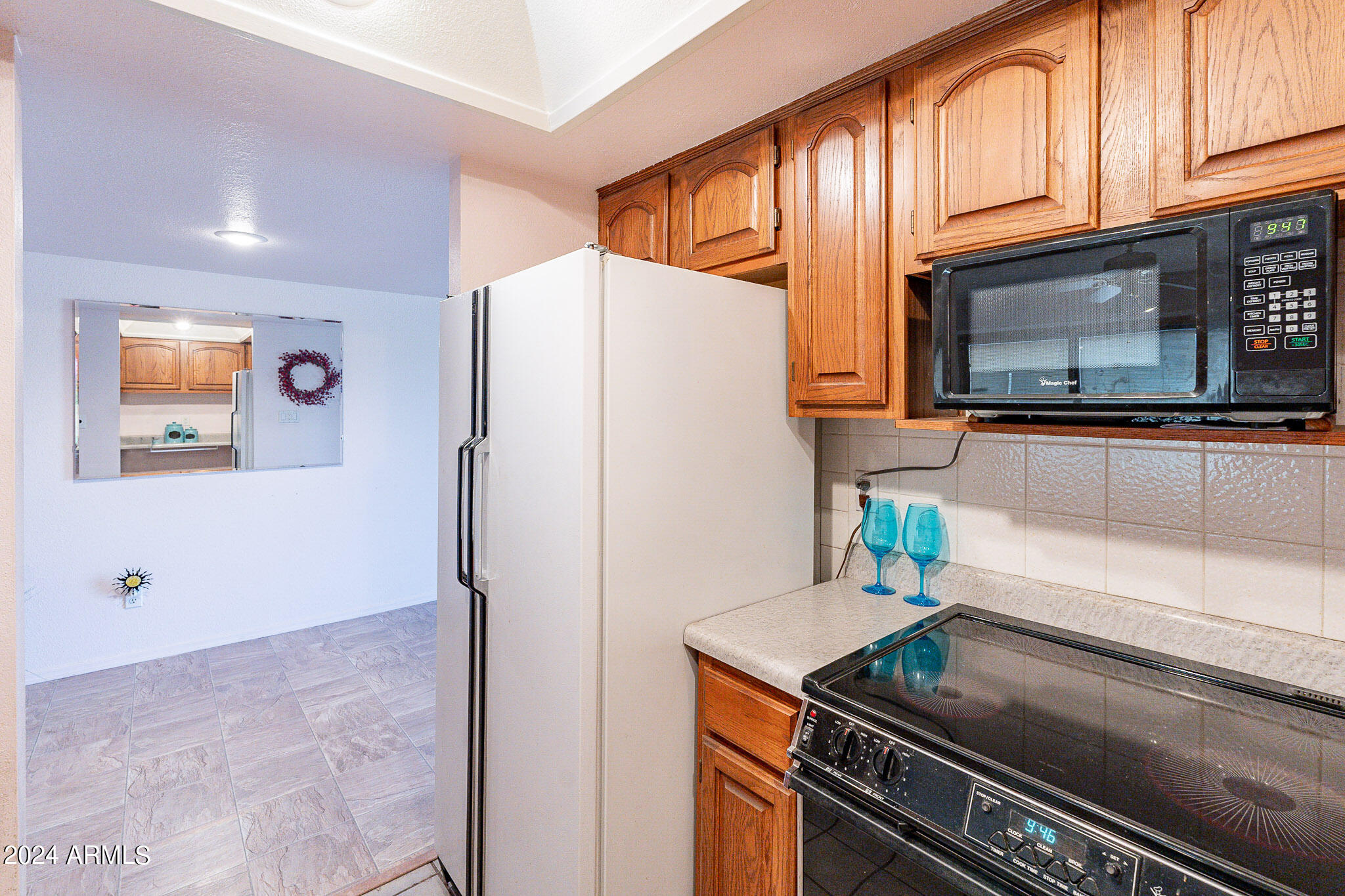 5138 North 81st Street Scottsdale, AZ 85250 - Photo 8 of 40 a white refrigerator freezer sitting inside of a kitchen