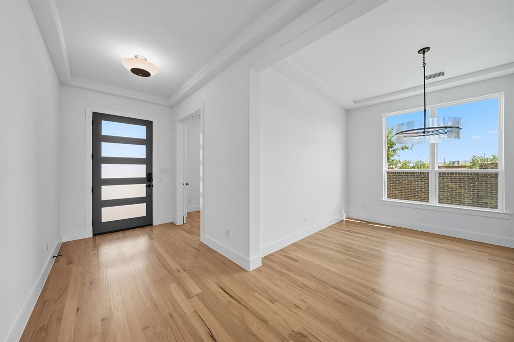 587 Mayfair Lane Frisco, TX 75033 - Photo 6 of 36 Foyer with light wood-style flooring and a chandelier