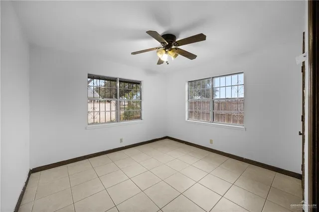 an empty room with windows and cabinet