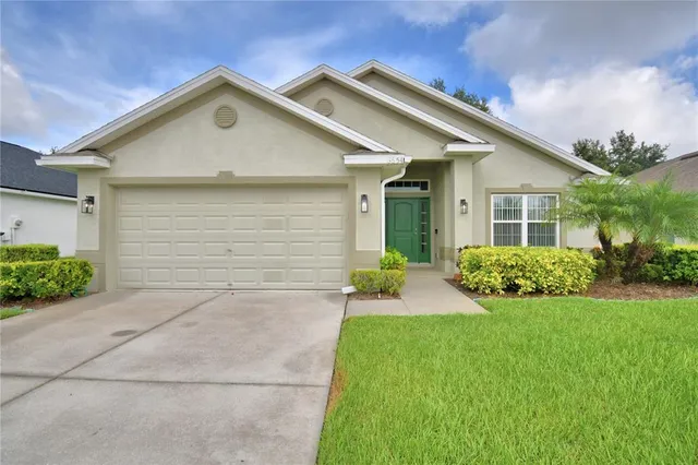 an empty room with wooden floor mirror and windows