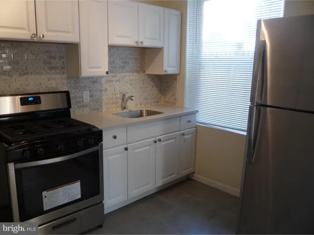 a kitchen with a stove and a refrigerator