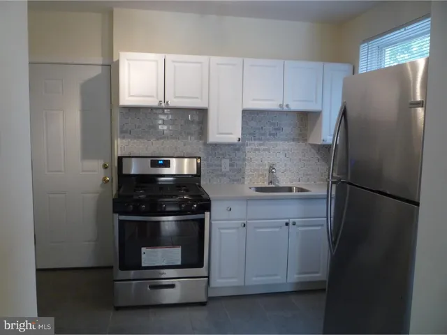 a kitchen with stainless steel appliances wooden cabinets and a stove