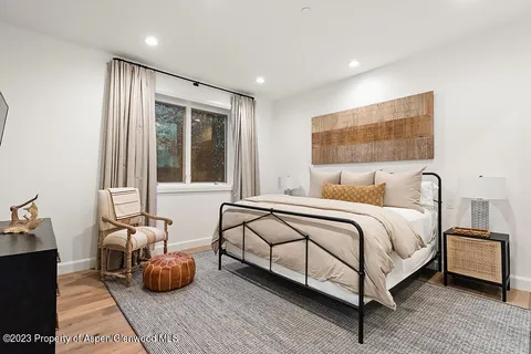 a spacious bedroom with a bed and window