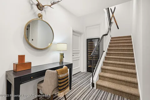a living room with furniture and a mirror