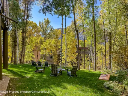 a view of yard with swimming pool and trees