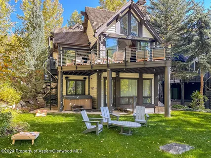 a front view of a house with a yard table and chairs