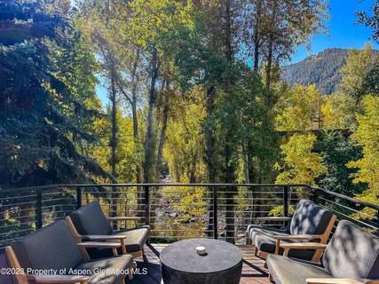 a view of a balcony with chair and potted plants
