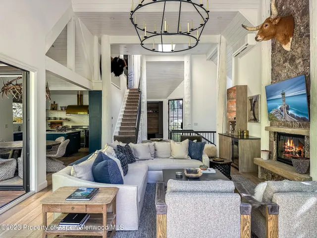 a living room with furniture fireplace and flat screen tv
