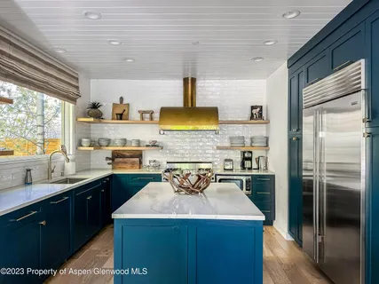 a kitchen with a sink a refrigerator and window