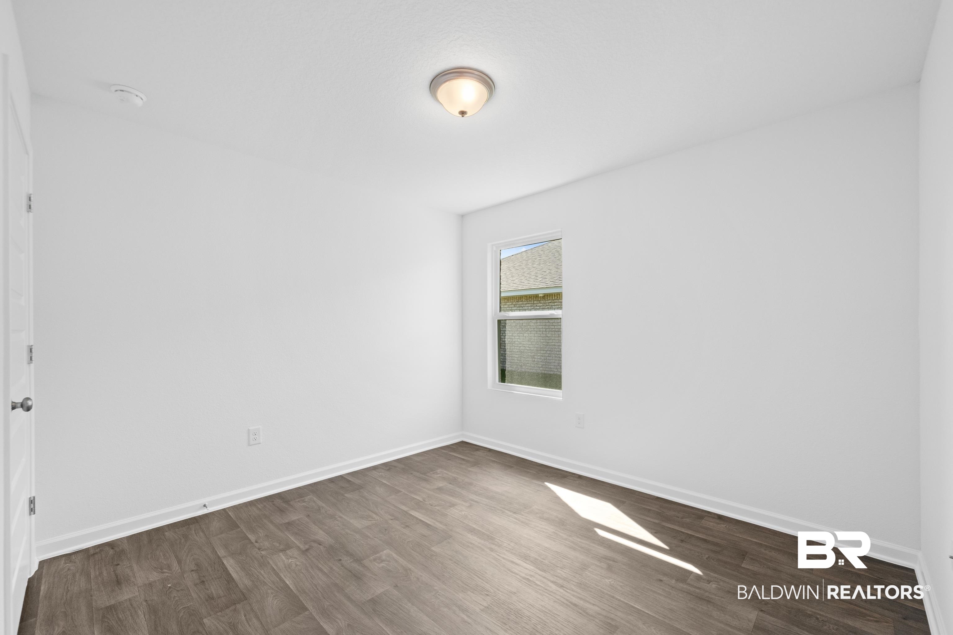 14615 Dayton Circle Foley, AL 36535 - Photo 8 of 27 Room featuring wood-finish flooring, a single window, and a flush-mount ceiling light fixture