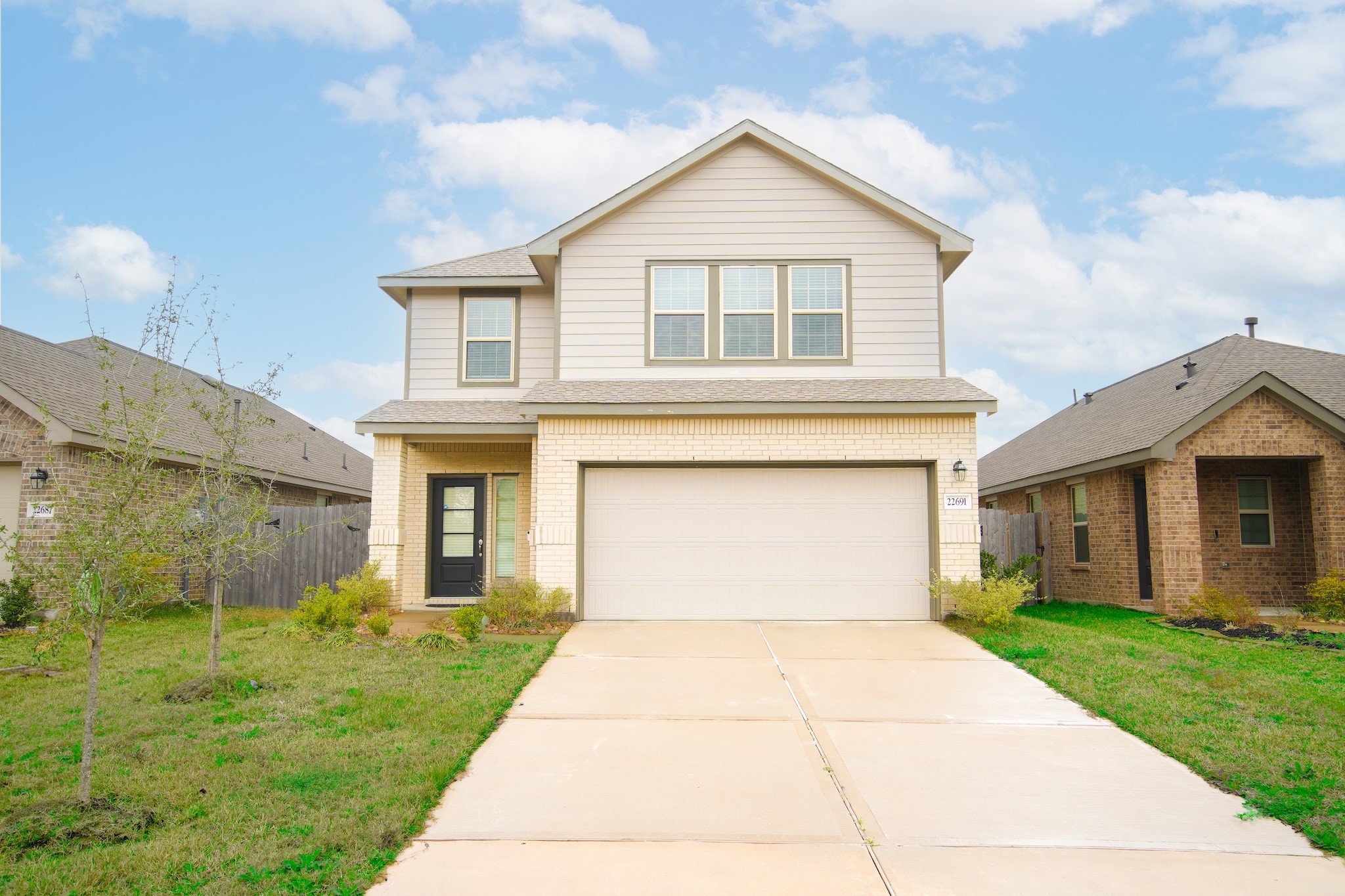 22691 Malvicino Drive New Caney, TX 77357 - Photo 1 of 12 a front view of a house with a yard and garage