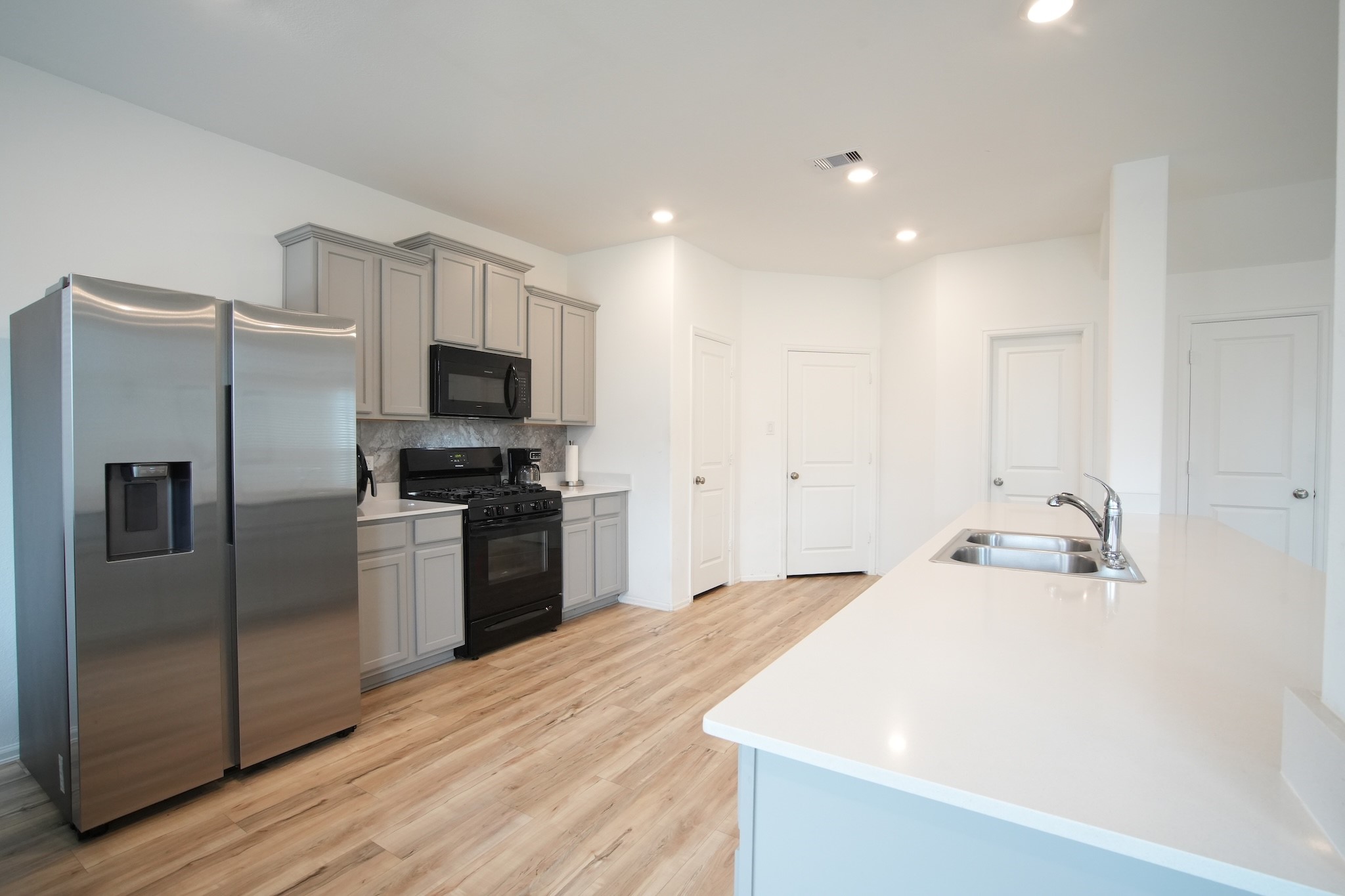 22691 Malvicino Drive New Caney, TX 77357 - Photo 4 of 12 a kitchen with a refrigerator and a sink