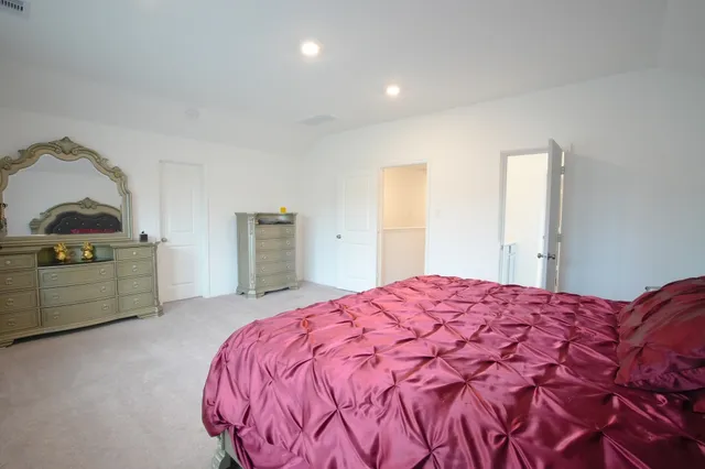 a bedroom with a bed and a dresser