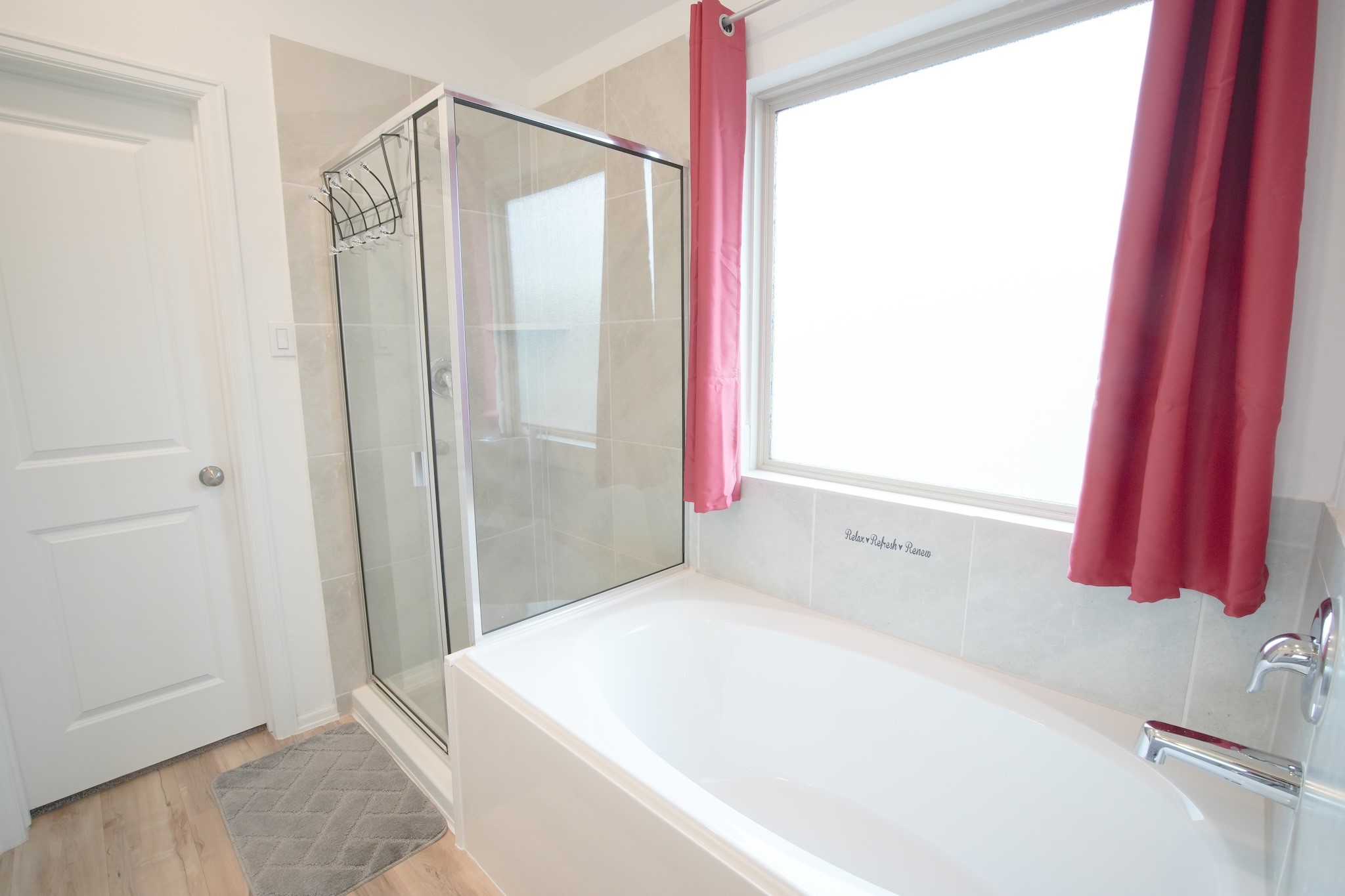 22691 Malvicino Drive New Caney, TX 77357 - Photo 8 of 12 a bathroom with a bathtub and a shower