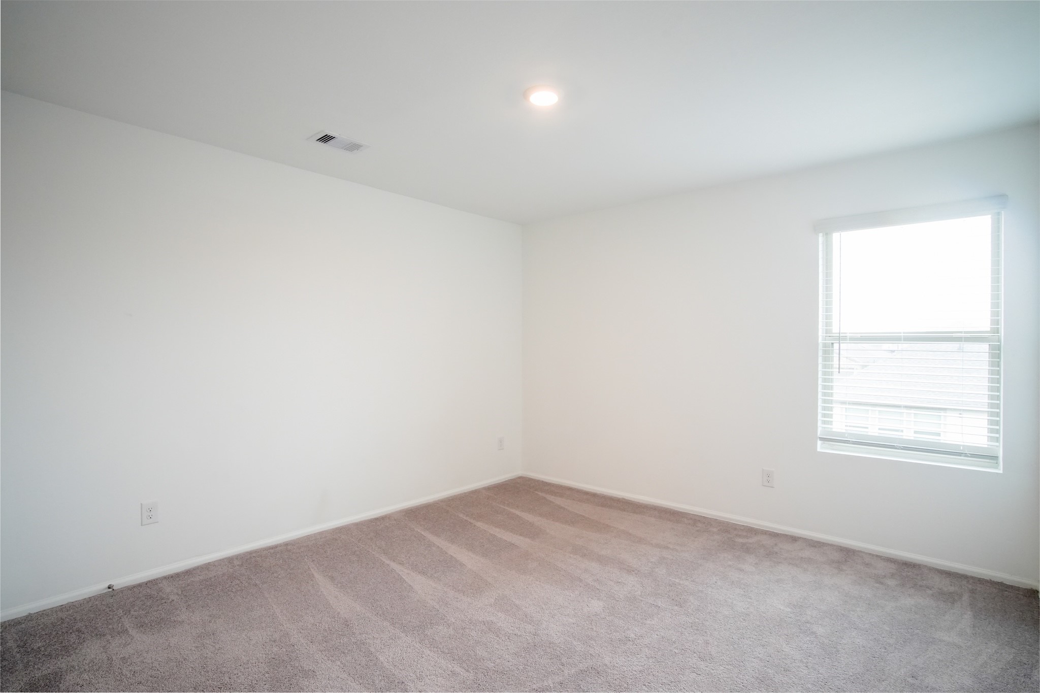 22691 Malvicino Drive New Caney, TX 77357 - Photo 10 of 12 an empty room with a window