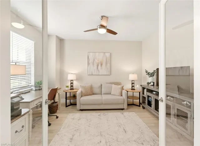 a living room with furniture and a large window