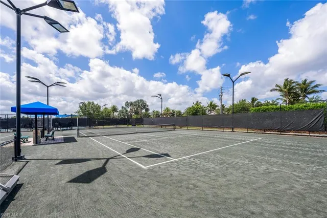 a living room with fireplace furniture and a large window
