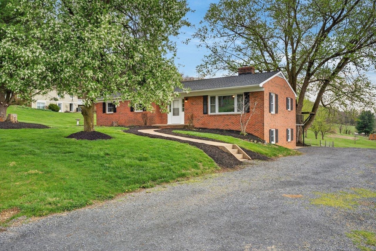 3259 Zion Church Road Broadway, VA 22815 - Photo 36 of 48 a front view of a house with a yard and trees