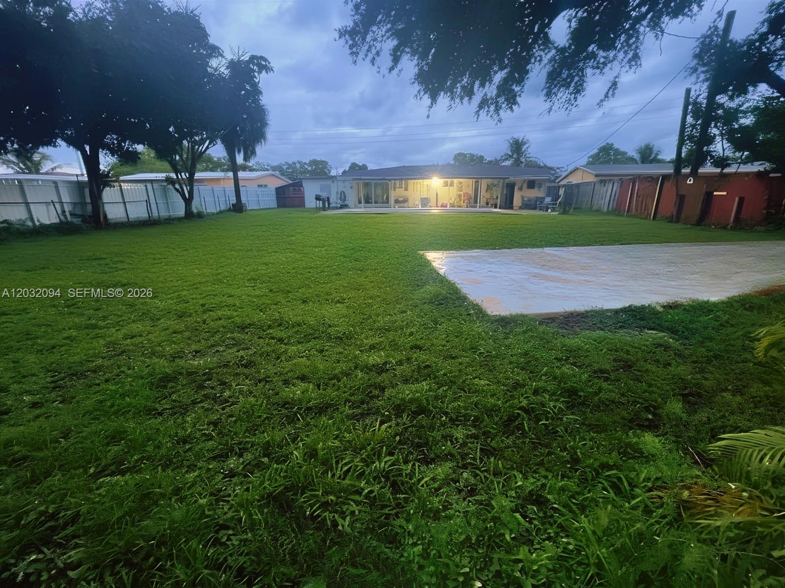 6492 Southwest 25th Street Miramar, FL 33023 - Photo 9 of 9 a view of a big yard with a house in the background
