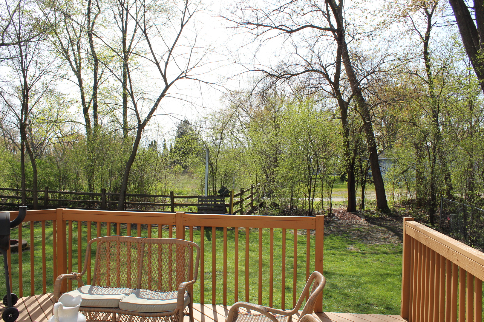 508 Northgate Road Lindenhurst, IL 60046 - Photo 26 of 27 a view of a wooden deck with large trees and wooden fence