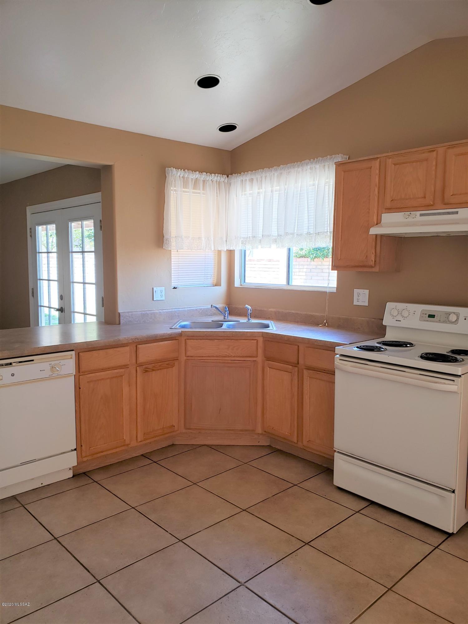 1200 Desert Dawn Drive Rio Rico, AZ 85648 - Photo 5 of 24 a kitchen with a sink window and cabinets