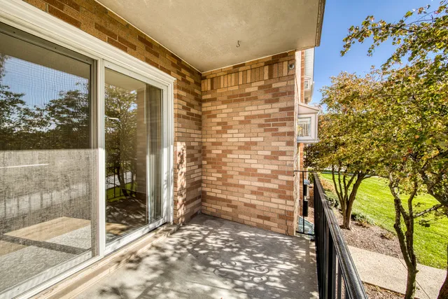 a view of a balcony with a floor to ceiling window and wooden fence