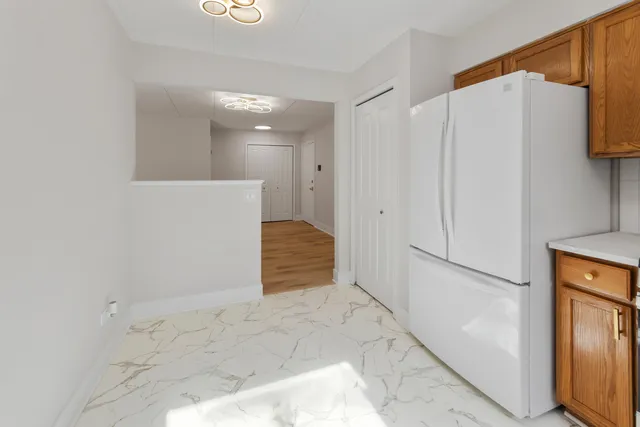 a kitchen with stainless steel appliances granite countertop a refrigerator and a stove top oven