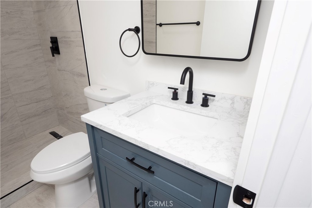 1571 Ricardo Street, Unit 2 Los Angeles, CA 90033 - Photo 7 of 29 a bathroom with a sink a toilet and shower curtain