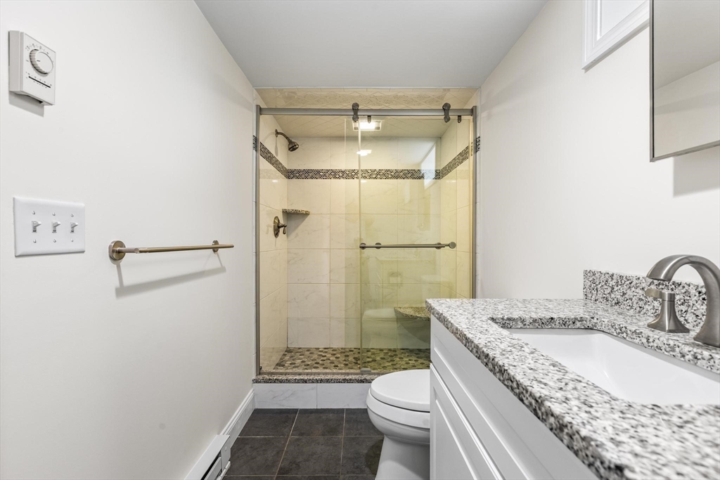 2 Deane Avenue, Unit A Winthrop, MA 02152 - Photo 11 of 18 a bathroom with a granite countertop sink toilet and shower