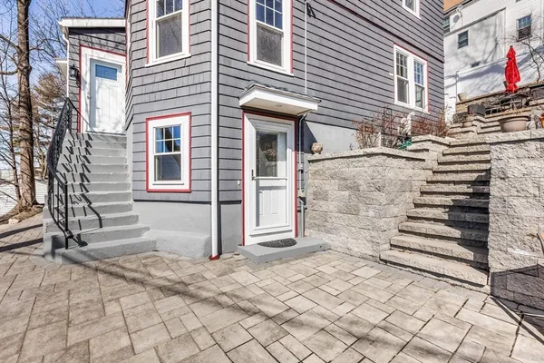 a view of a house with a door and a yard