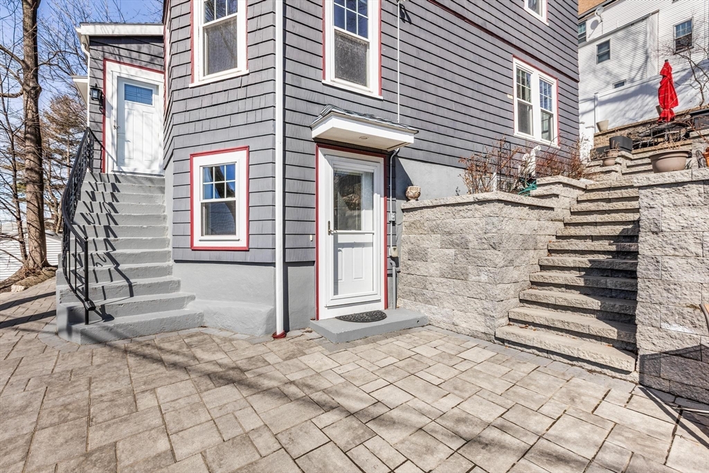 2 Deane Avenue, Unit A Winthrop, MA 02152 - Photo 14 of 18 a view of a house with a door and a yard