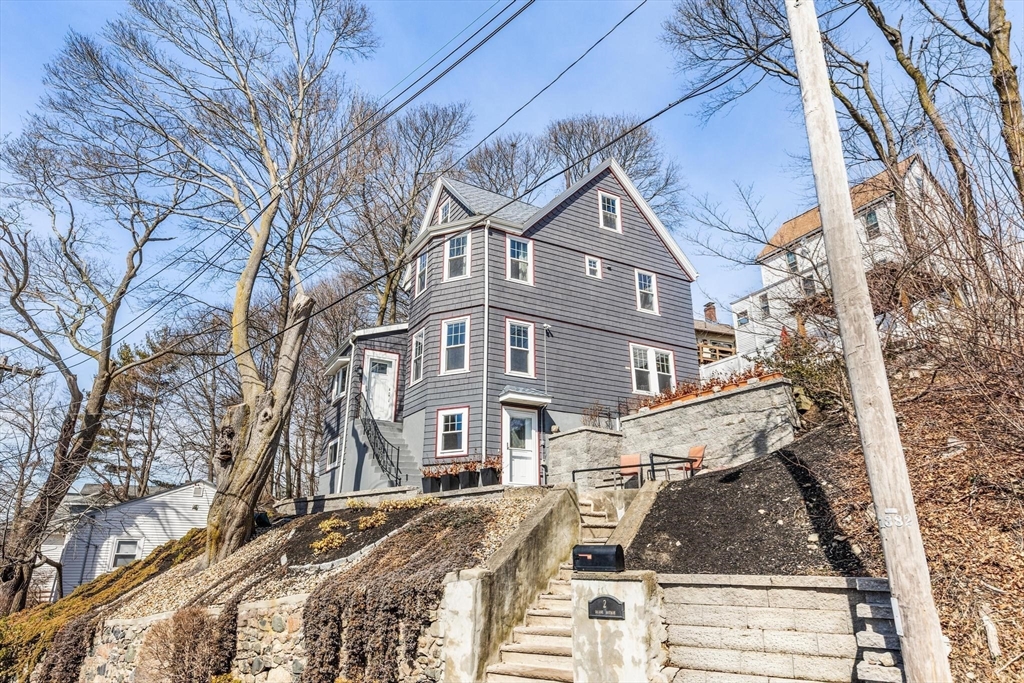2 Deane Avenue, Unit A Winthrop, MA 02152 - Photo 16 of 18 a front view of a residential apartment building with a yard