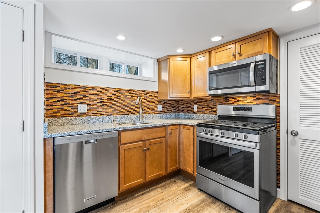 2 Deane Avenue, Unit A Winthrop, MA 02152 - Photo 2 of 18 a kitchen with granite countertop cabinets stainless steel appliances and a sink