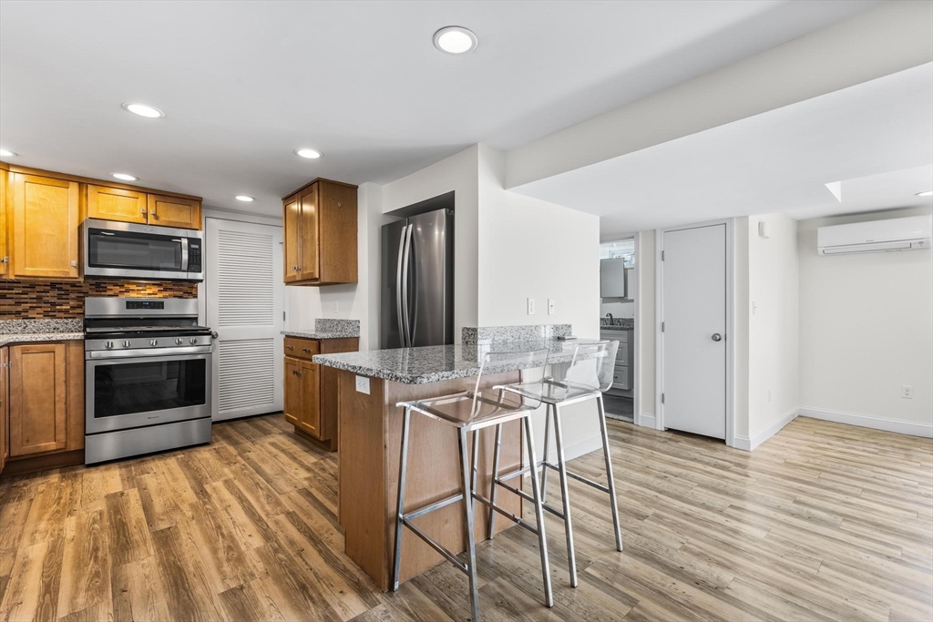2 Deane Avenue, Unit A Winthrop, MA 02152 - Photo 4 of 18 a kitchen that has a lot of cabinets a sink and appliances in it