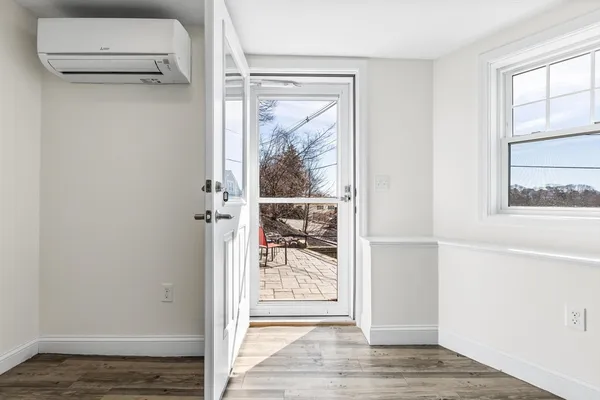 a view of a small space with wooden floor and a window