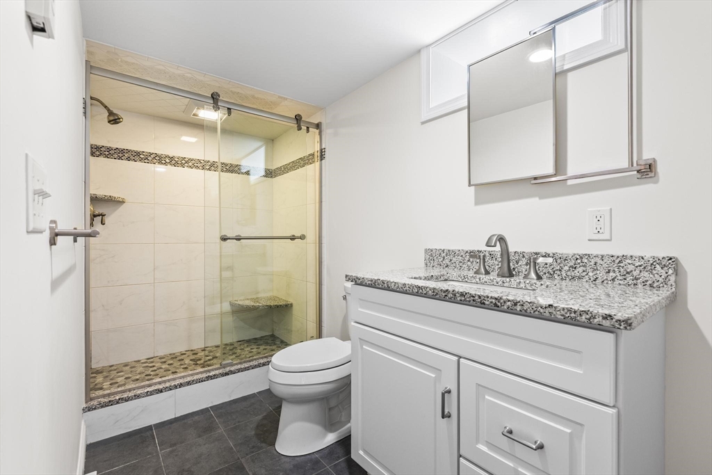 2 Deane Avenue, Unit A Winthrop, MA 02152 - Photo 10 of 18 a bathroom with a granite countertop sink toilet and shower