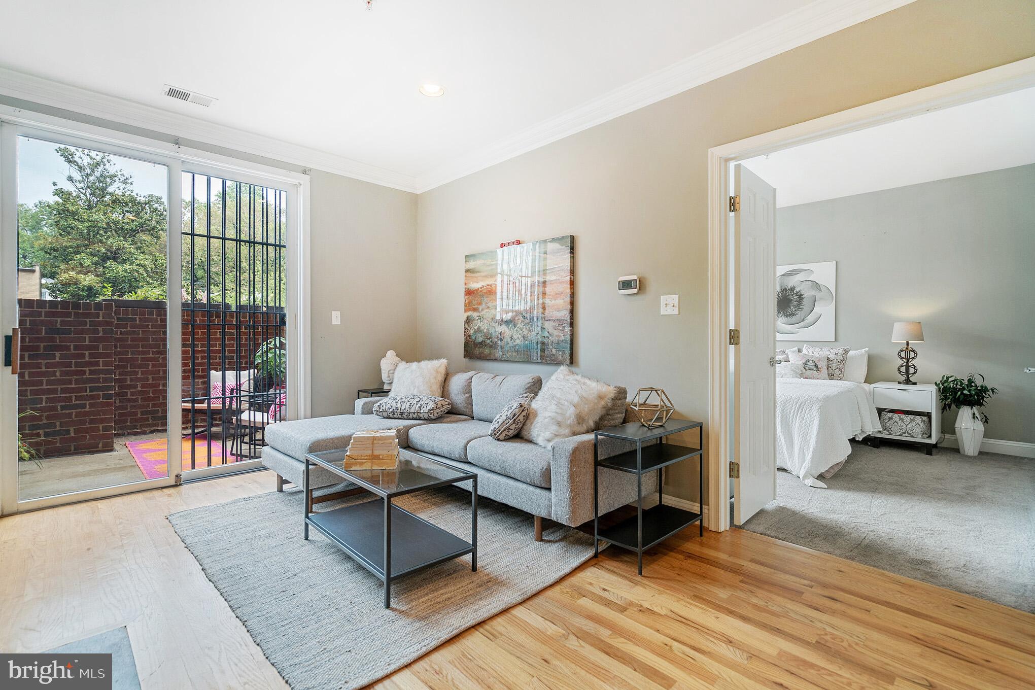 2801 Connecticut Avenue Northwest, Unit 16 Washington, DC 20008 - Photo 2 of 17 a living room with furniture and a large window