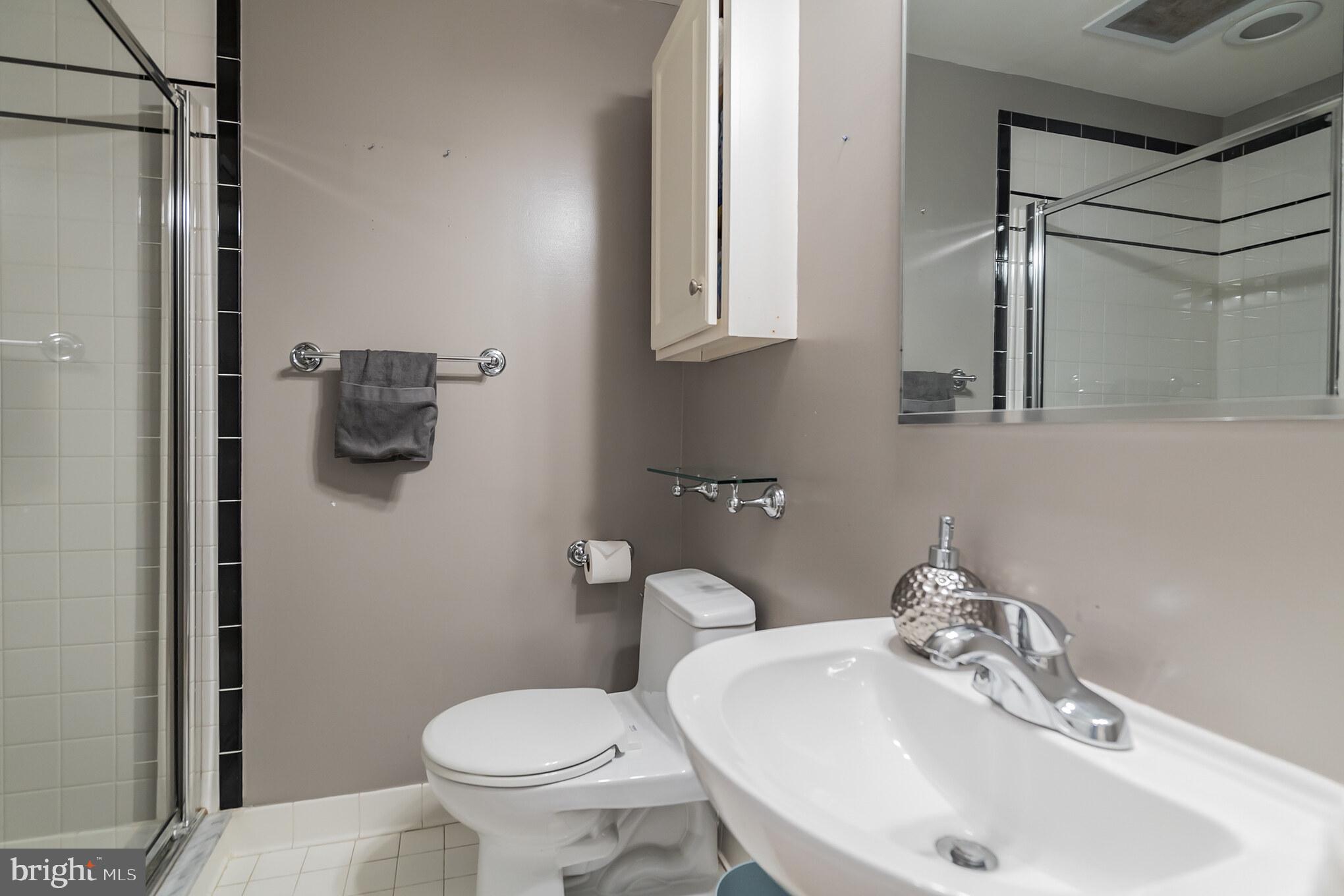 2801 Connecticut Avenue Northwest, Unit 16 Washington, DC 20008 - Photo 10 of 17 a bathroom with a sink toilet and mirror