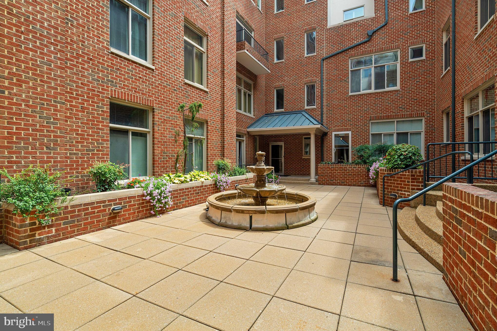 2801 Connecticut Avenue Northwest, Unit 16 Washington, DC 20008 - Photo 15 of 17 a front view of a building with dining table and chairs with potted plants