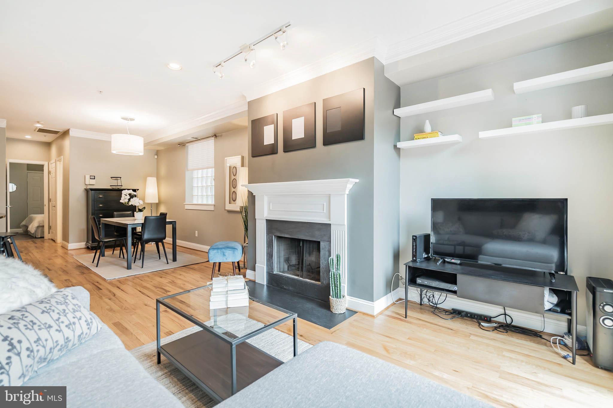 2801 Connecticut Avenue Northwest, Unit 16 Washington, DC 20008 - Photo 17 of 17 a living room with furniture a flat screen tv and a fireplace