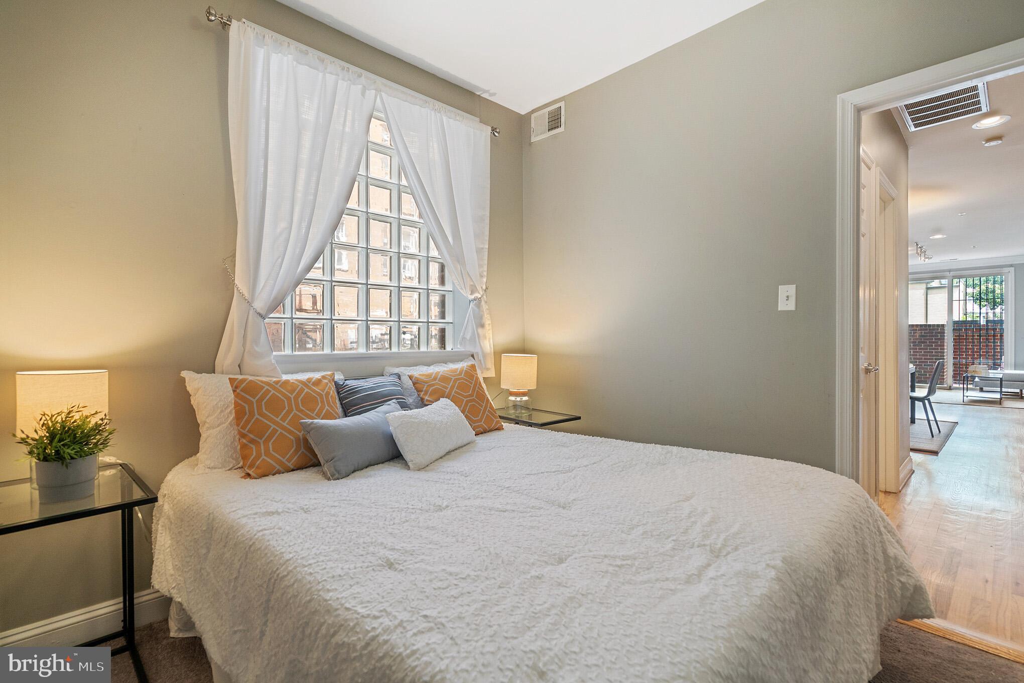 2801 Connecticut Avenue Northwest, Unit 16 Washington, DC 20008 - Photo 9 of 17 a bedroom with a bed and a large window