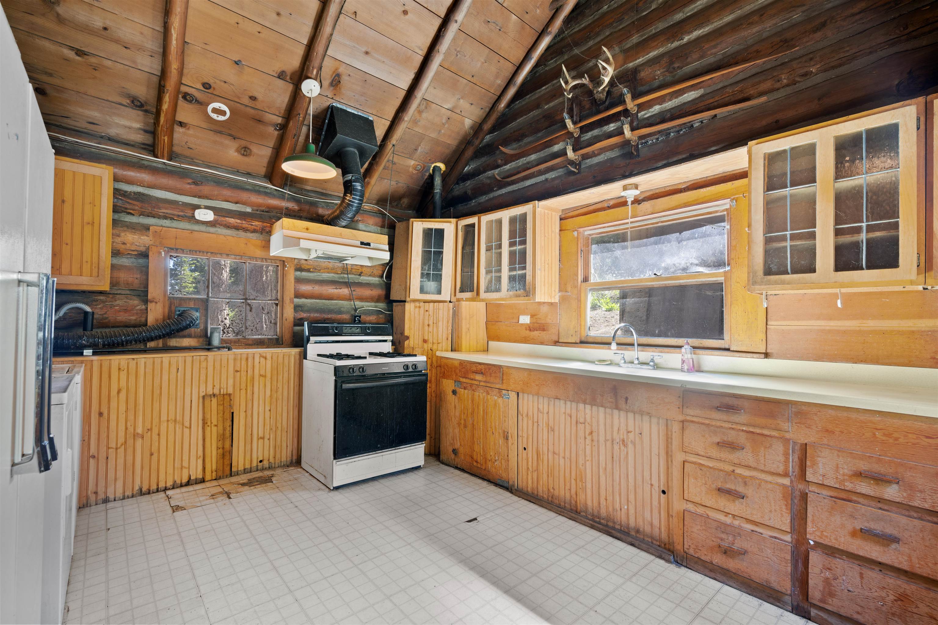 40 Gull Street Mammoth Lakes, CA 93546 - Photo 8 of 44 a kitchen with stainless steel appliances granite countertop a stove a sink and a granite counter tops with a large window