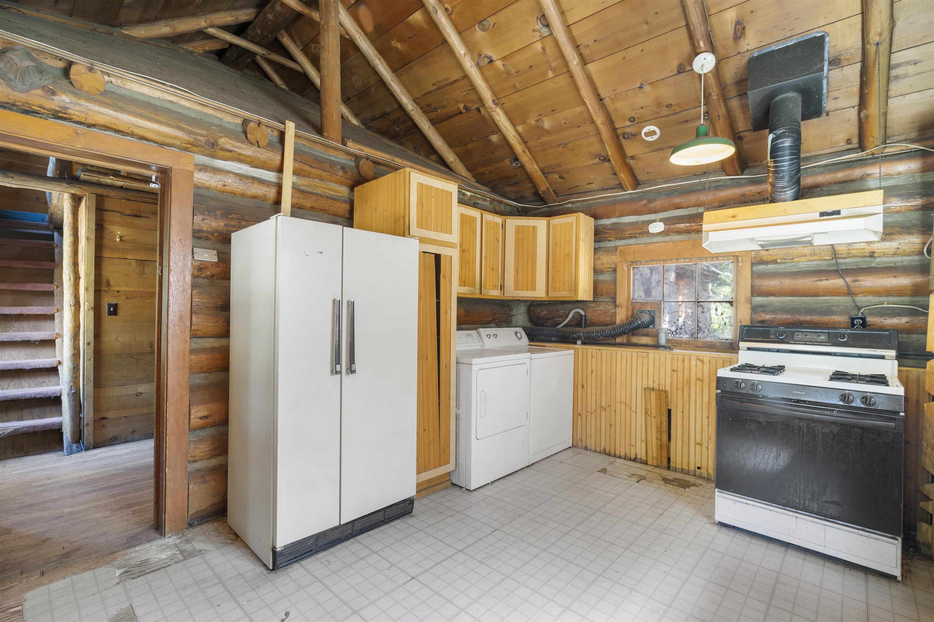 40 Gull Street Mammoth Lakes, CA 93546 - Photo 9 of 44 a kitchen with refrigerator and cabinets