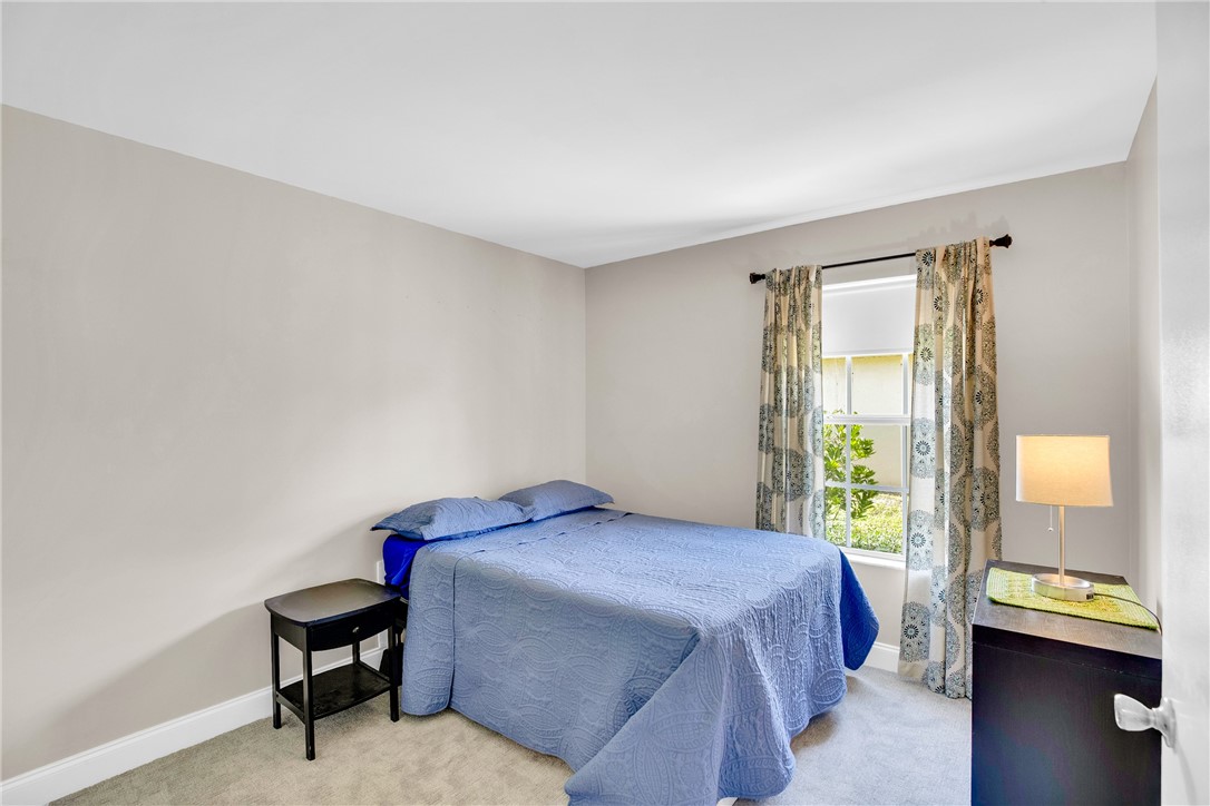 405 Columbus Street Sebastian, FL 32958 - Photo 18 of 36 a bedroom with a bed and a window