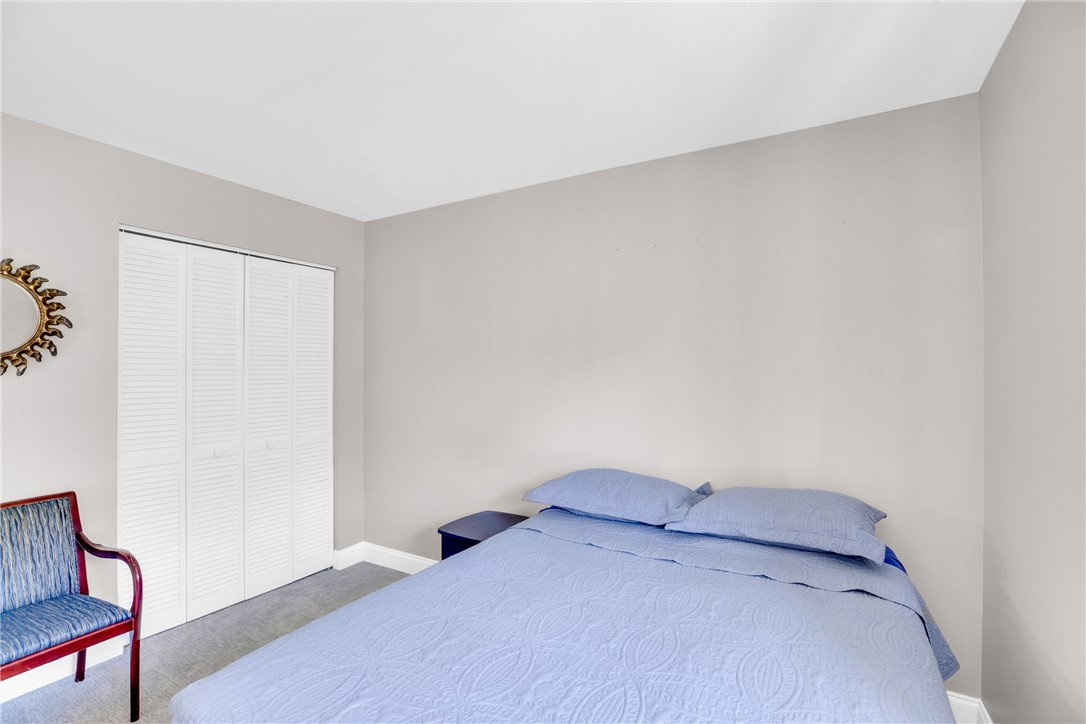 405 Columbus Street Sebastian, FL 32958 - Photo 19 of 36 a bedroom with a bed and a chair