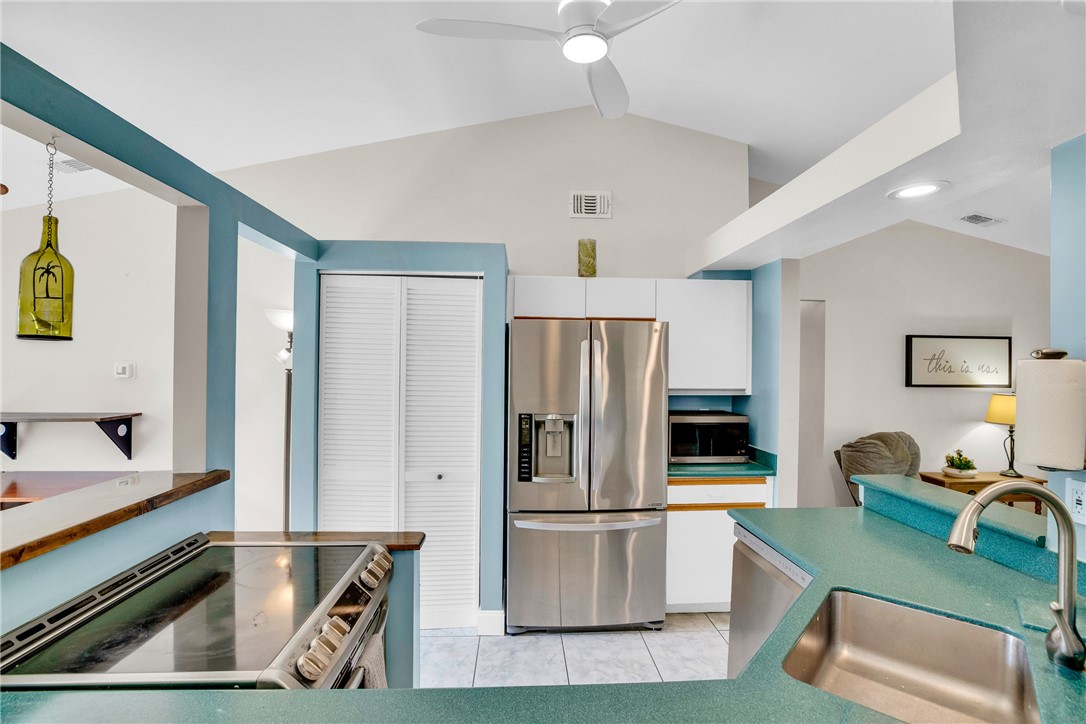 405 Columbus Street Sebastian, FL 32958 - Photo 6 of 36 a kitchen with stainless steel appliances granite countertop a refrigerator and a sink