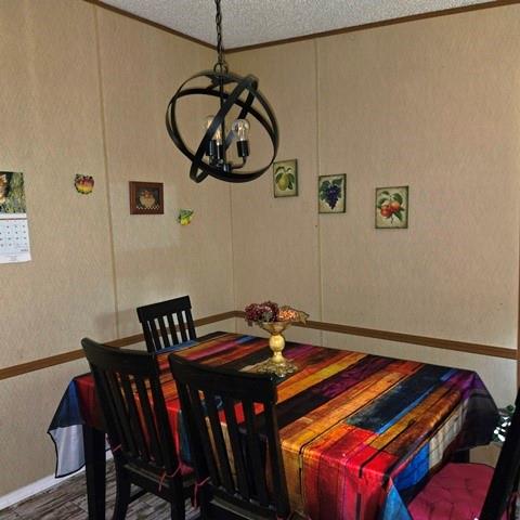 108 Elm Street Mabank, TX 75156 - Photo 11 of 22 a bedroom with a bed and a chandelier