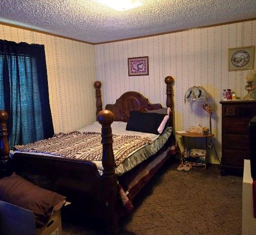 108 Elm Street Mabank, TX 75156 - Photo 16 of 22 a bed sitting in a bedroom next to a window and a lamp