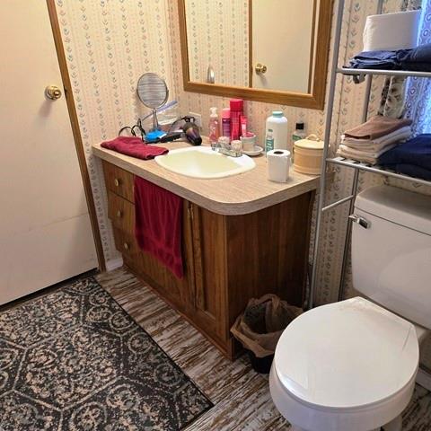 108 Elm Street Mabank, TX 75156 - Photo 17 of 22 a bathroom with a sink a toilet and mirror