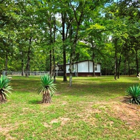 108 Elm Street Mabank, TX 75156 - Photo 4 of 22 a house view with a garden space